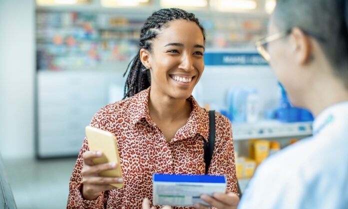 Pharmacist helping a customer choose a product Close up of a pharmacist helping a customer choose a product