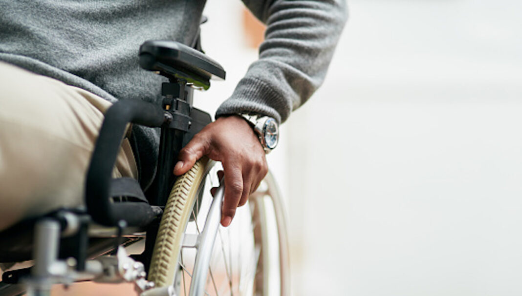 Cropped shot of an unrecognizable senior man sitting in his wheelchair at home