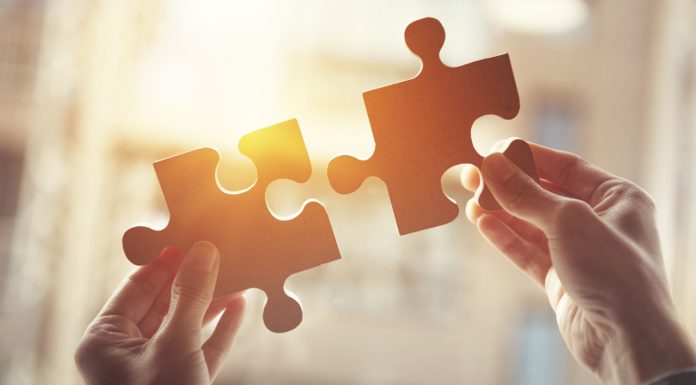 PSA urges unity between GPs and pharmacists hands joining jigsaw puzzle pieces