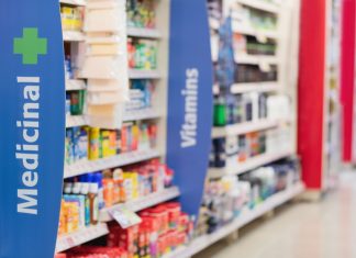 The business of pharmacy: tensions in retail healthcare pharmacy shelves showing medicines and vitamins