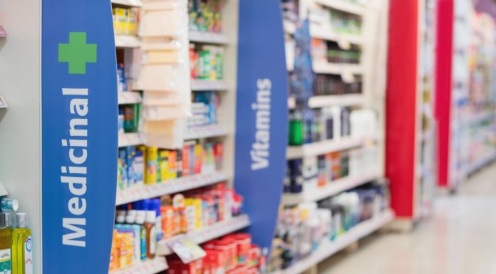 The business of pharmacy: tensions in retail healthcare pharmacy shelves showing medicines and vitamins