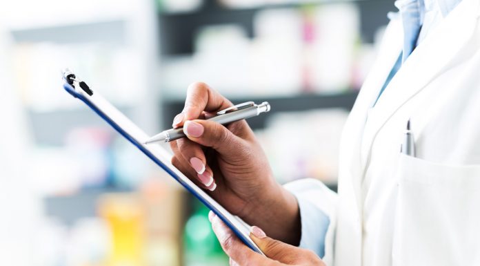 Just what the pharmacist ordered pharmacist holding clipboard and pen