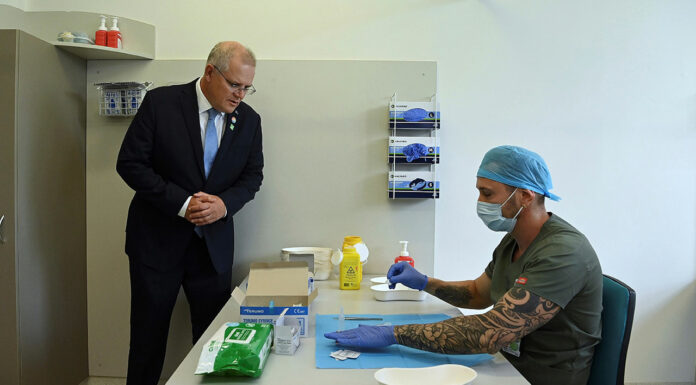Pharmacists at forefront of Australia’s vaccine rollout Prime Minister Scott Morrison looks on as pharmacist Branko Radojkovic prepares a simulation of the COVID-19 vaccine at Sydney's Royal Prince Alfred Hospital last week