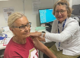 First Queensland community pharmacists join COVID-19 vaccine effort Pharmacist Sarah Parry-Okeden vaccinating a patient at Acton Health Pharmacy