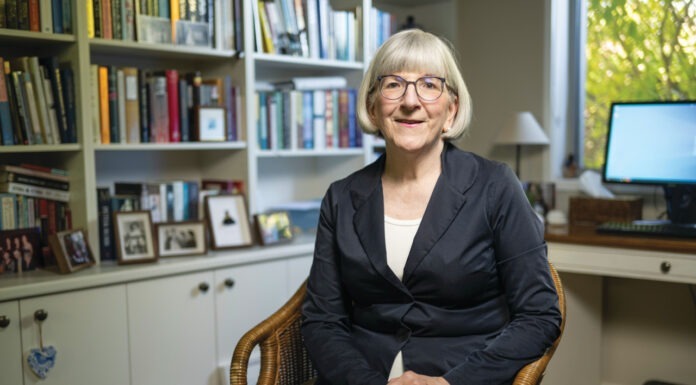 PSA’s resident accredited pharmacist Photo of Sarah Gillespie MPS sitting down inside her library