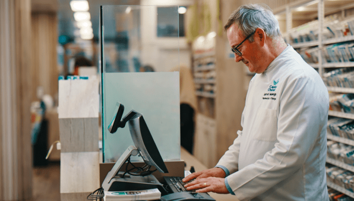 Pharmacist taking notes on a computer